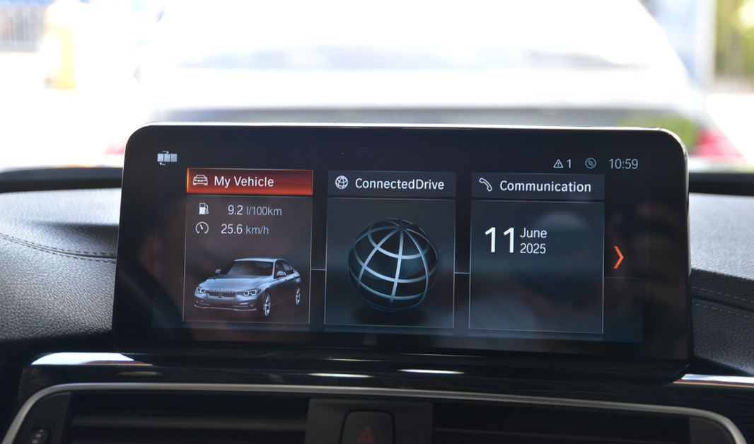 BMW infotainment system display showing vehicle stats, connectivity, and communication