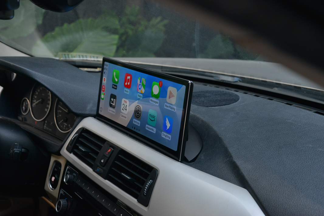 BMW dashboard with integrated Apple CarPlay display, showing app icons