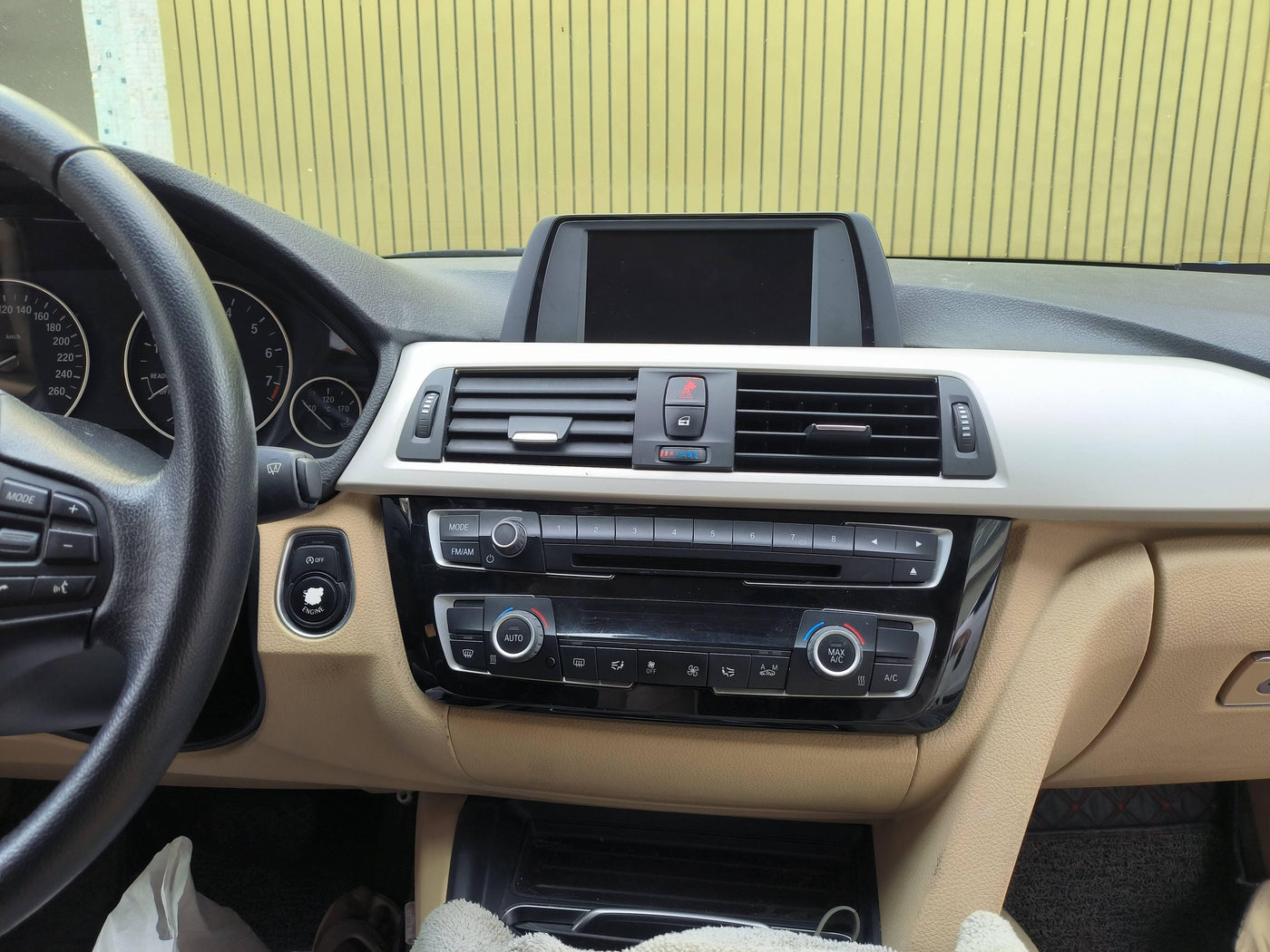 BMW 3 Series dashboard: steering wheel, control panel, beige interior