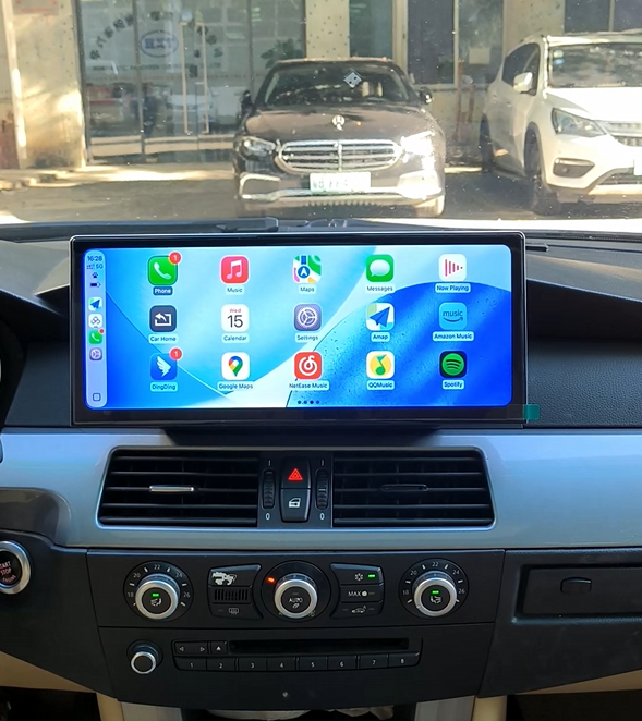 Wide touchscreen CarPlay dashboard in car showing navigation and music apps