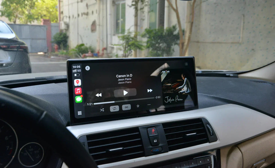 car dashboard infotainment screen displaying apple carplay music player while parked