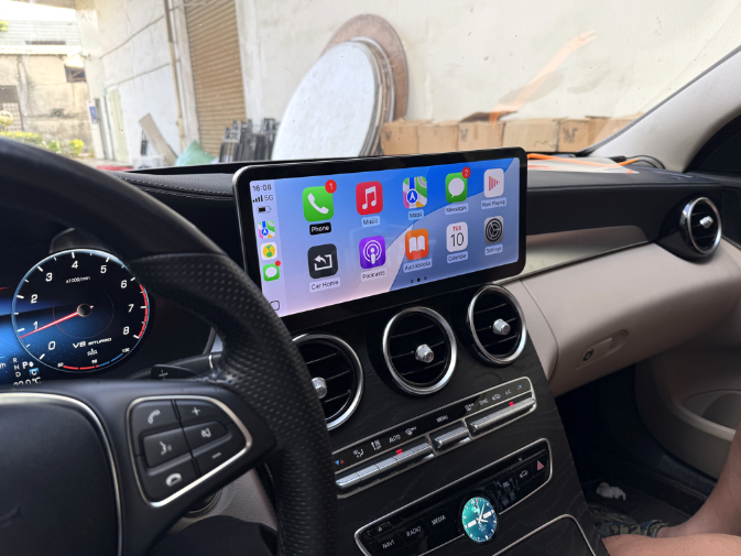 Mercedes dashboard with widescreen CarPlay display showing apps